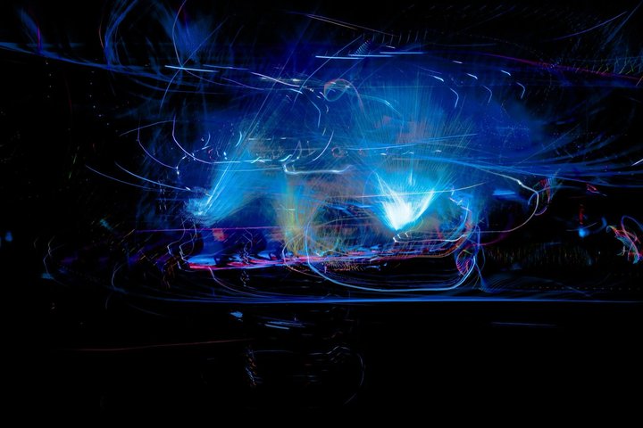Blue stage lights and looping light trails at night