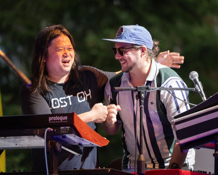 Two musicians smiling together at the stage