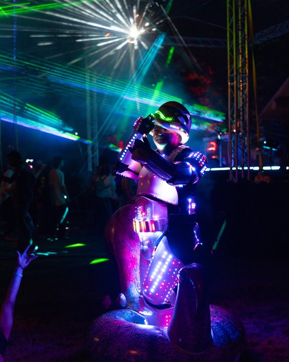Performer illuminated by blue and purple light at night