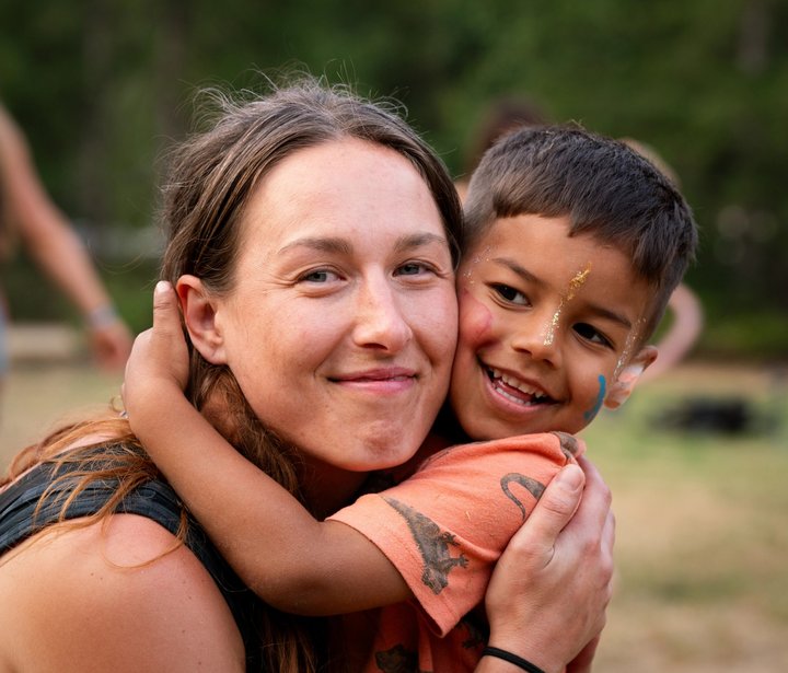 An adult and child smiling together at the festival